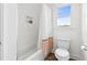 Bright bathroom featuring a shower-tub, toilet and window letting in lots of natural light at 1355 Cashiers Way, Roswell, GA 30075