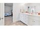 This dual sink vanity bathroom features bright white cabinets and chrome fixtures at 1355 Cashiers Way, Roswell, GA 30075