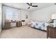 This spacious bedroom offers a ceiling fan, large windows, and room for a desk at 1355 Cashiers Way, Roswell, GA 30075