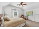 Bright bedroom featuring vaulted ceiling, neutral carpet, ceiling fan, and natural light at 1355 Cashiers Way, Roswell, GA 30075