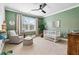This spacious Bedroom features a ceiling fan, crib, rocking chair and great natural light at 1355 Cashiers Way, Roswell, GA 30075