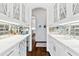 Bright butler's pantry features mirrored backsplash, wine cooler, and ample counter space at 1355 Cashiers Way, Roswell, GA 30075
