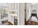 Chic butler's pantry with a wine cooler, mirrored backsplash, and seamless access to dining at 1355 Cashiers Way, Roswell, GA 30075