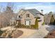 Two-story brick house with stone accents, mature trees, and lush bushes at 1355 Cashiers Way, Roswell, GA 30075