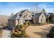 Beautiful two-story brick home with a manicured front yard and elegant landscaping at 1355 Cashiers Way, Roswell, GA 30075