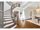 Bright foyer featuring hardwood floors, grand staircase, and elegant chandelier at 1355 Cashiers Way, Roswell, GA 30075