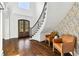 Welcoming foyer with staircase, dark wood floors, and stylish seating area at 1355 Cashiers Way, Roswell, GA 30075