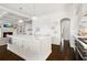 Bright kitchen with white cabinets, large island, stainless appliances, and dark hardwood floors at 1355 Cashiers Way, Roswell, GA 30075