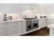 Well-appointed kitchen with stainless steel appliances, custom cabinetry, and quartz countertops at 1355 Cashiers Way, Roswell, GA 30075