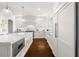 Modern kitchen with white cabinets, island with seating, and stainless steel appliances at 1355 Cashiers Way, Roswell, GA 30075