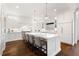 Spacious kitchen featuring large island with seating, custom cabinets, and modern lighting at 1355 Cashiers Way, Roswell, GA 30075