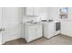 Clean laundry room with sink, washer, dryer, tile floor and overhead storage at 1355 Cashiers Way, Roswell, GA 30075