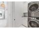 Hallway view of a modern laundry room with stainless steel front load washer and dryer at 1355 Cashiers Way, Roswell, GA 30075