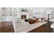 Cozy living room with fireplace, stylish furniture, and large area rug at 1355 Cashiers Way, Roswell, GA 30075