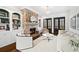 Cozy living room with a stone fireplace, built-in bookshelves, and French doors at 1355 Cashiers Way, Roswell, GA 30075