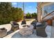 Relax by the stone fire pit, surrounded by comfortable seating on the beautiful outdoor patio at 1355 Cashiers Way, Roswell, GA 30075