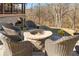 Gather around the stone fire pit with wicker chairs on a lovely backyard patio at 1355 Cashiers Way, Roswell, GA 30075