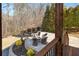 Inviting stone patio with an outdoor fire pit and cozy seating, set against a wooded backdrop at 1355 Cashiers Way, Roswell, GA 30075