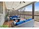 Relaxing covered porch with stylish wicker furniture and view of wooded surroundings at 1355 Cashiers Way, Roswell, GA 30075