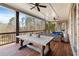 Inviting outdoor porch with comfortable seating and a rustic wooden dining table overlooking the backyard at 1355 Cashiers Way, Roswell, GA 30075
