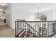 This staircase features dark wrought iron railings and wood steps and lots of natural light at 1355 Cashiers Way, Roswell, GA 30075
