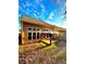 A sunny view of the backyard with an outdoor seating area and a well-maintained lawn at 3476 Harvest Ridge Ln, Buford, GA 30519