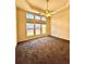 Bright bedroom with large windows, neutral carpet, and a ceiling fan at 3476 Harvest Ridge Ln, Buford, GA 30519