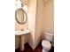 Half bathroom with pedestal sink, oval mirror, and hardwood floors at 3476 Harvest Ridge Ln, Buford, GA 30519