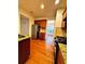 Galley kitchen featuring granite countertops, stainless steel appliances, and hardwood flooring at 3476 Harvest Ridge Ln, Buford, GA 30519