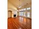 Open living room with a cozy fireplace, large windows, and plenty of light at 3476 Harvest Ridge Ln, Buford, GA 30519