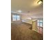 Carpeted loft space with a large window and view of the backyard at 3476 Harvest Ridge Ln, Buford, GA 30519