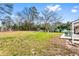 Grassy backyard with mature trees and a patio, ideal for outdoor entertaining at 1646 Flicker Rd, Jonesboro, GA 30238