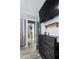 Bright hallway leading into a bedroom with TV, shelving, and closet at 1646 Flicker Rd, Jonesboro, GA 30238