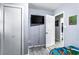This bedroom has gray laminate flooring, a wall-mounted TV, and a closet at 1646 Flicker Rd, Jonesboro, GA 30238