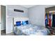 Bedroom featuring a bed with white headboard and blue decorative pillows, as well as open closet at 1646 Flicker Rd, Jonesboro, GA 30238