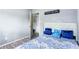 Bedroom featuring a bed with white headboard and blue decorative pillows and an ensuite door at 1646 Flicker Rd, Jonesboro, GA 30238