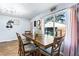 Dining room with a large window view of the backyard and an eye-catching modern chandelier at 1646 Flicker Rd, Jonesboro, GA 30238