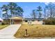 Charming ranch-style home with covered carport and well-maintained front yard at 1646 Flicker Rd, Jonesboro, GA 30238