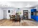 Open-concept kitchen and dining area with modern lighting, blue cabinets, and a functional storage area at 1646 Flicker Rd, Jonesboro, GA 30238