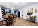 Open-concept kitchen and dining area featuring bright blue cabinets, modern lighting and wood flooring at 1646 Flicker Rd, Jonesboro, GA 30238