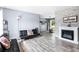 Open living room with decorative fireplace, stone accent wall and wood-look flooring offers a cozy atmosphere at 1646 Flicker Rd, Jonesboro, GA 30238