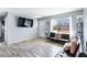 Bright living room showcases stylish futon seating and large window views, complemented by modern wood floors at 1646 Flicker Rd, Jonesboro, GA 30238