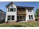 Two-story home featuring a wooden balcony, well-manicured lawn, and large windows at 4435 Beechnut Cir, Cumming, GA 30028