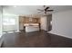 Open-concept kitchen featuring a center island, modern pendant lighting and dark hardwood floors at 4435 Beechnut Cir, Cumming, GA 30028