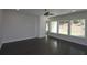 A well-lit living room featuring hardwood floors and large windows with scenic views at 4435 Beechnut Cir, Cumming, GA 30028