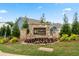 Stone monument sign for Garrett Preserve with fresh landscaping and partial view of blue homes in the background at 224 Silver Leaf Trce, Douglasville, GA 30134