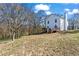 View of the home's backyard featuring a spacious lawn and wooden deck, perfect for outdoor gatherings at 392 Fourth St, Forest Park, GA 30297