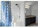 Bright bathroom featuring a tub, shower, vanity, granite countertops, and blue shower curtain at 392 Fourth St, Forest Park, GA 30297