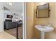 Cozy half bath featuring a pedestal sink, mirror, and tan colored walls at 392 Fourth St, Forest Park, GA 30297