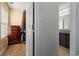 Hallway featuring an opened closet with a dresser and a partial view into the bathroom at 392 Fourth St, Forest Park, GA 30297